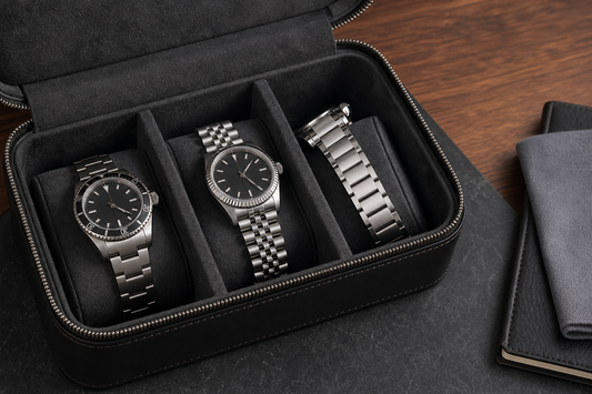 Open travel watch case with metal bracelet watches separated by soft dividers